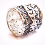 Ring intricately hand pierced in detail with wave pattern