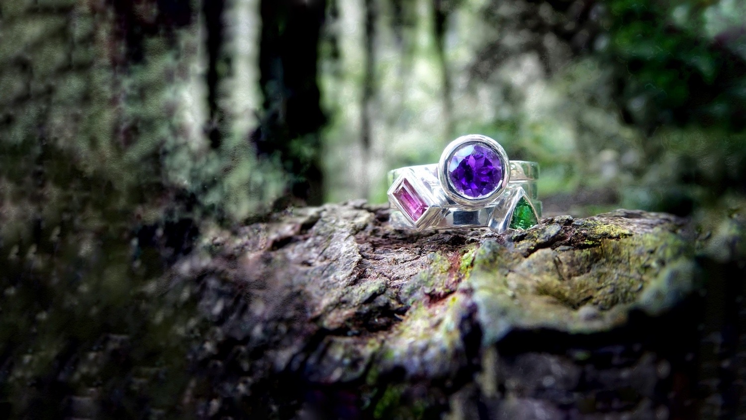 Three stacking rings set with amethyst, tsavorite and pink tourmaline.