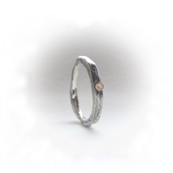 Contemporary silver ring set with diamond.