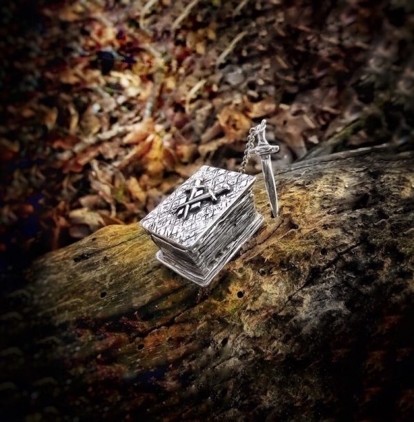 A silver locket in the shape of a book